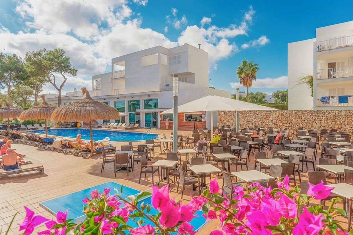 Poolside terrace with pink flowers at MarSenses Ferrera Blanca Hotel, Mallorca