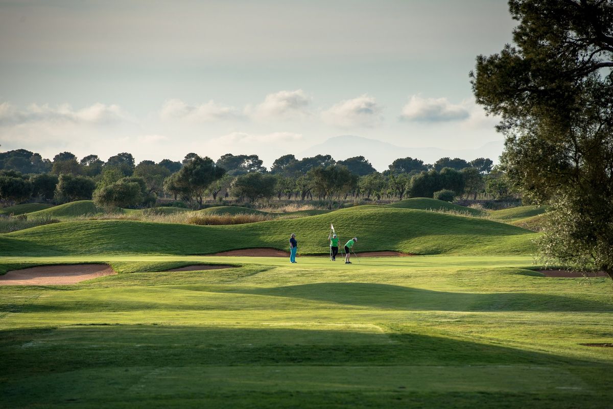 Golfers on a rolling fairway at Son Antem West golf course, Mallorca