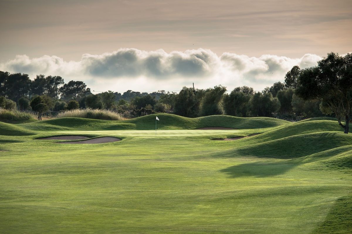Rolling fairway under dramatic clouds at Son Antem West golf course, Mallorca