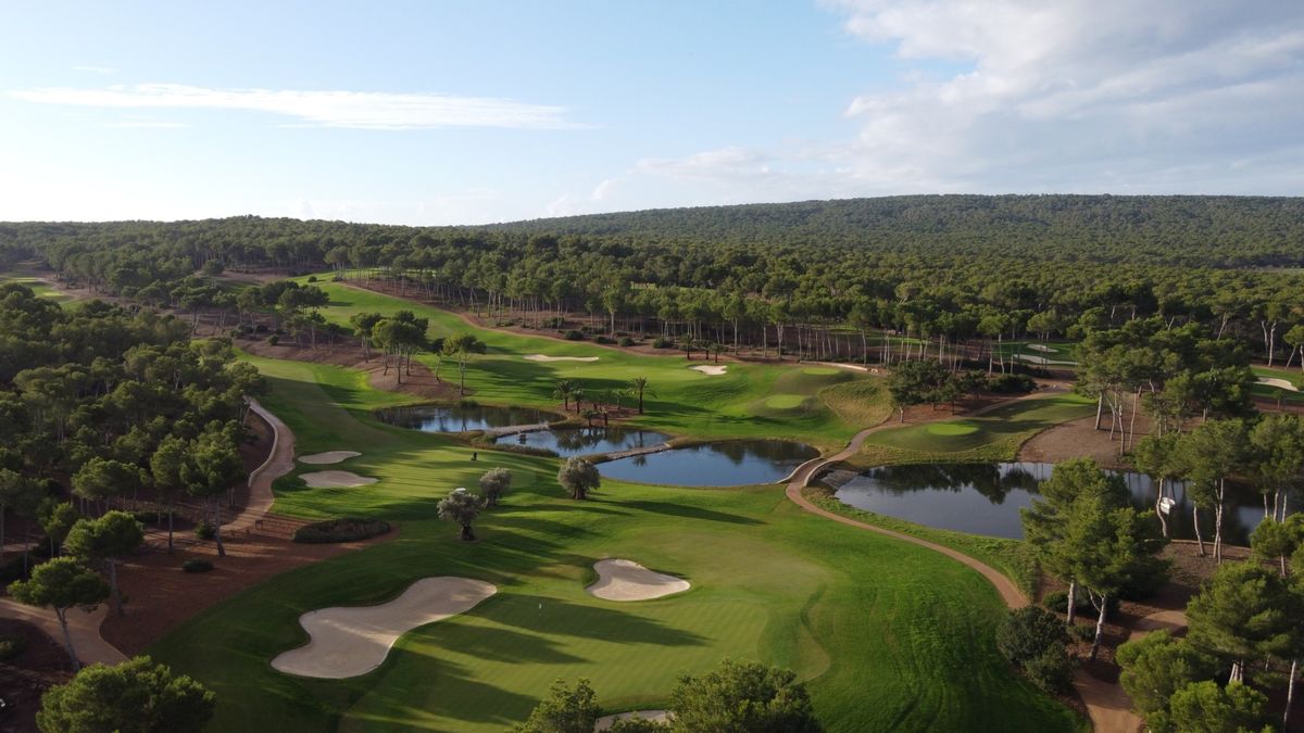 Aerial view of fairways and lakes surrounded by pine forest at T-Golf Calvià, Mallorca