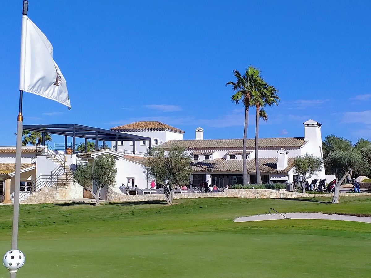 Clubhouse with palm trees behind the flagstick at T-Golf Calvià, Mallorca