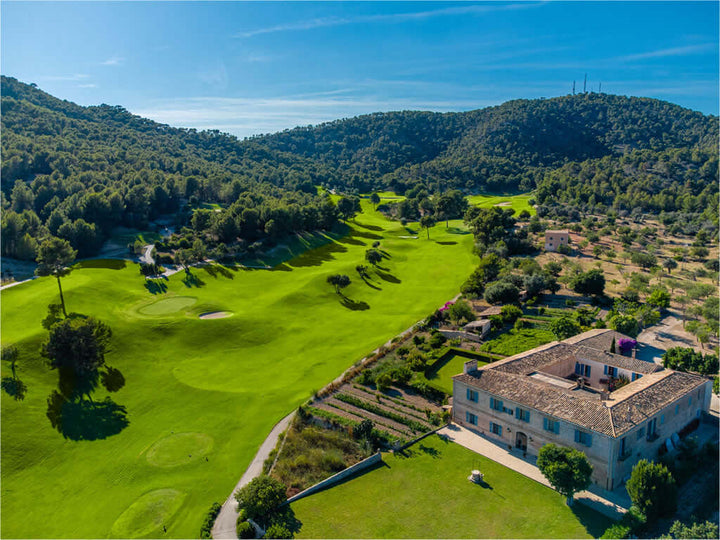 Rent2Play.Golf 18-hole Green Fee at Golf de Andratx course, showing the lush green fairways and scenic golf landscape.